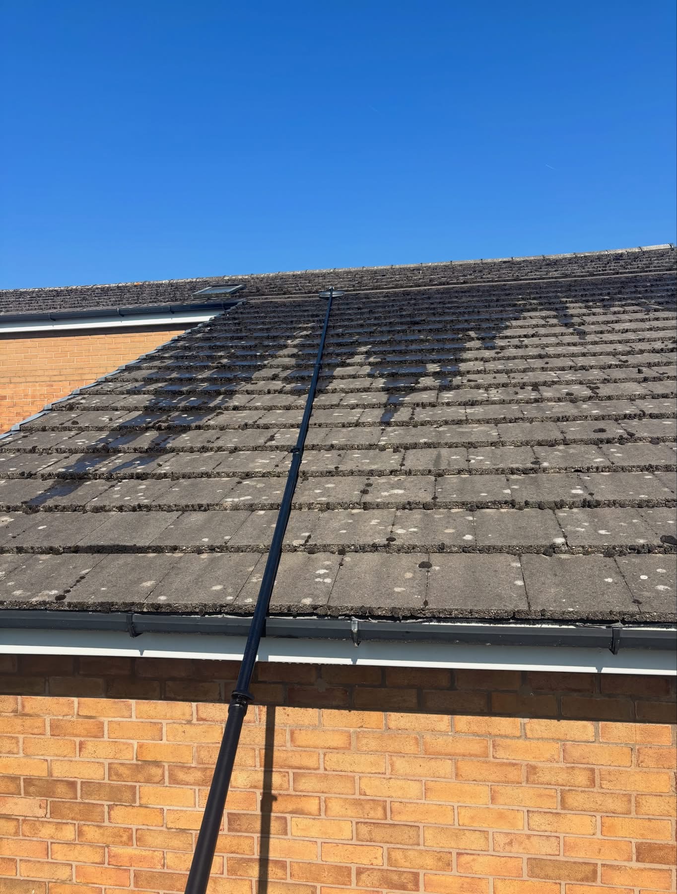 Concrete tile roof mid soft wash, moss and dirt lifted